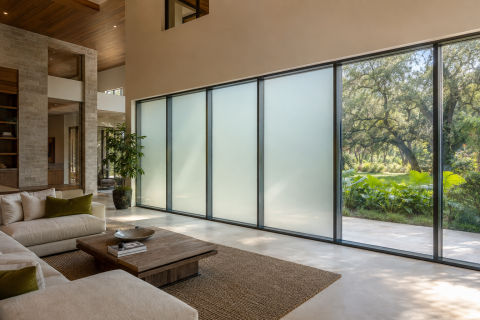 Switchable smart film installed on floor-to-ceiling windows in a Baton Rouge home.