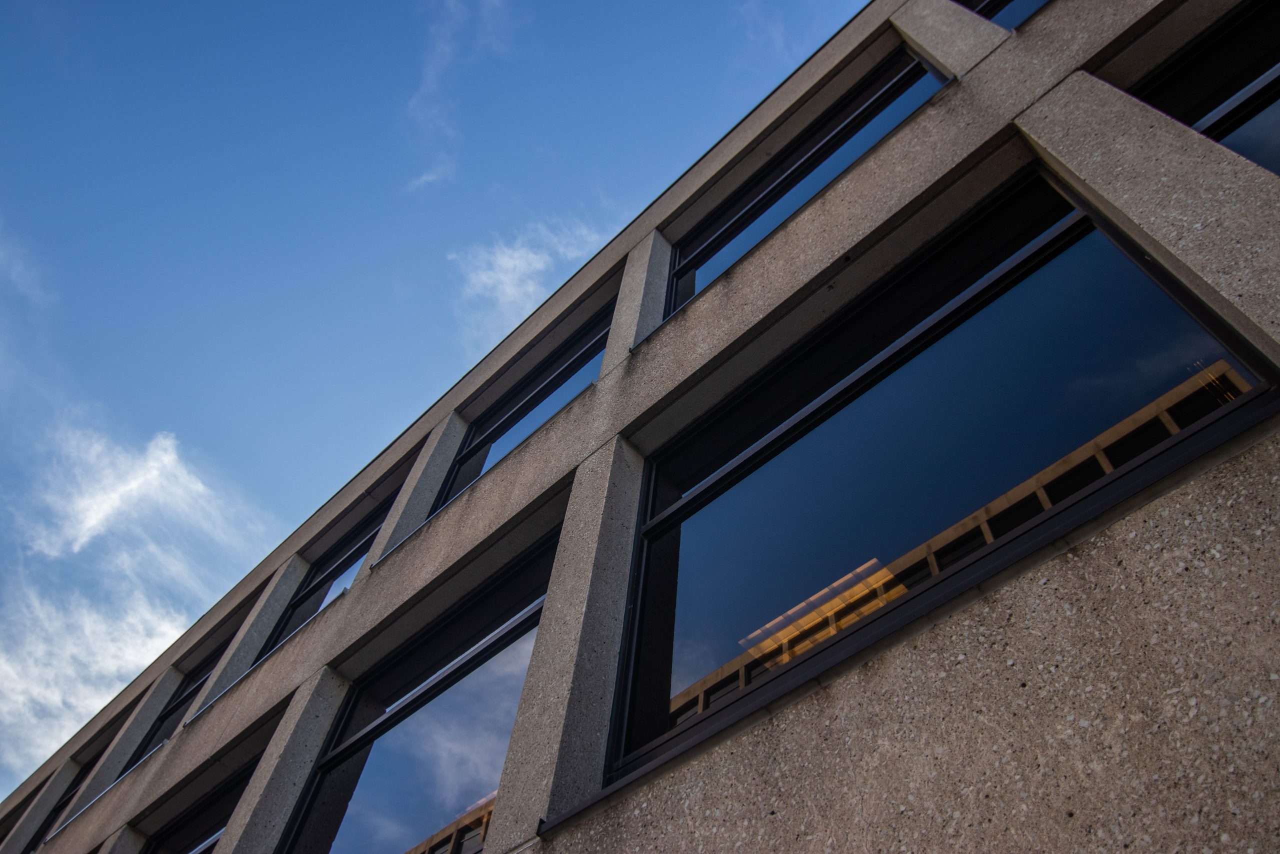 Close-up of commercial window tinting on a multi-story office building